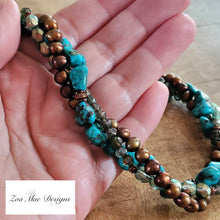Load image into Gallery viewer, Turquoise Twist Necklace held in hand.
