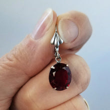Load image into Gallery viewer, Vintage Ruby Crystal Earrings held in fingers.
