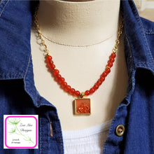 Load image into Gallery viewer, Antique Gold Gemstone and Glitter Necklace on model.
