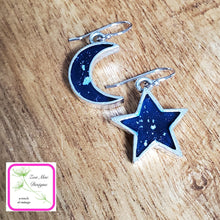 Load image into Gallery viewer, Moon and Star Earrings on wooden background.

