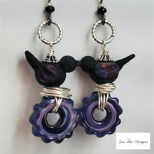 Load image into Gallery viewer, Nested Bird on Gear Earrings (Black and Purple)
