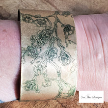Load image into Gallery viewer, Cherry Blossom Etched Brass Cuff on wrist.
