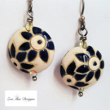 Load image into Gallery viewer, Ceramic Flower Disk Earrings hanging.
