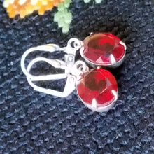 Load image into Gallery viewer, Vintage Ruby Crystal Earrings on tapestry.
