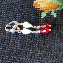 Load image into Gallery viewer, Vintage Milk Glass Crystal and Siam Swarovski Earrings on tapestry.
