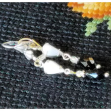 Load image into Gallery viewer, Vintage Milk Glass Crystal and Jet Swarovski Earrings on tapestry.
