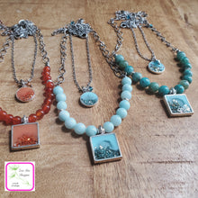 Load image into Gallery viewer, Antique Silver Gemstone and Glitter Necklace shown with coordinating Antique Silver Glitter Necklaces on wooden background.
