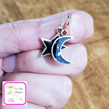 Load image into Gallery viewer, Moon and Star Earrings held in fingers.
